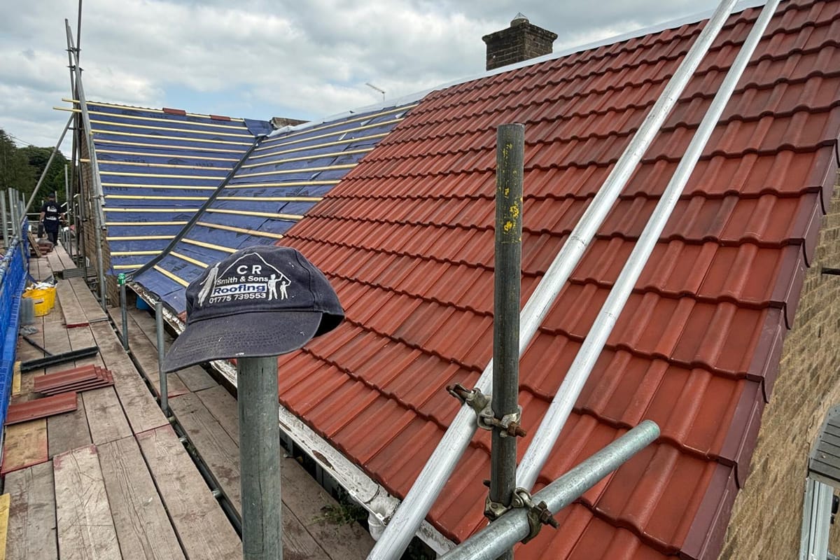 A C R Smith & Son roofer laying new roof tiles