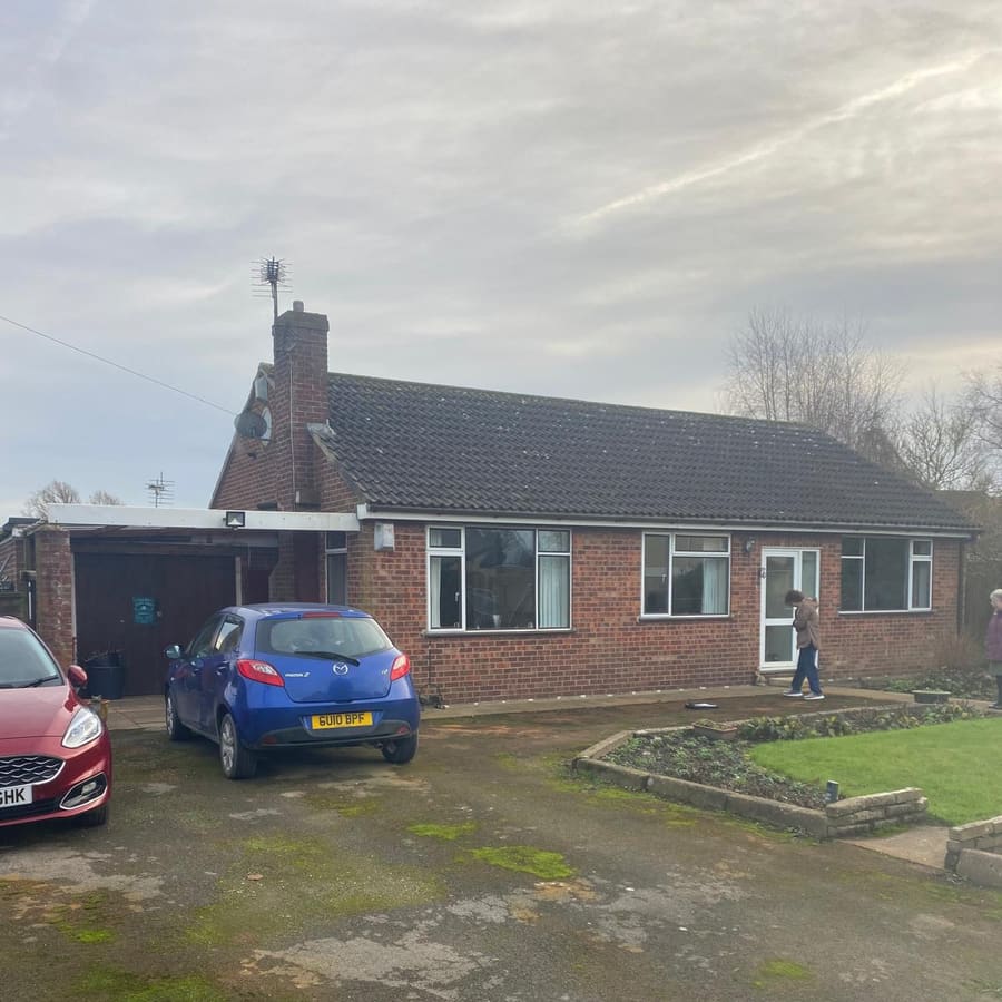 A bungalow with its old roof before work began