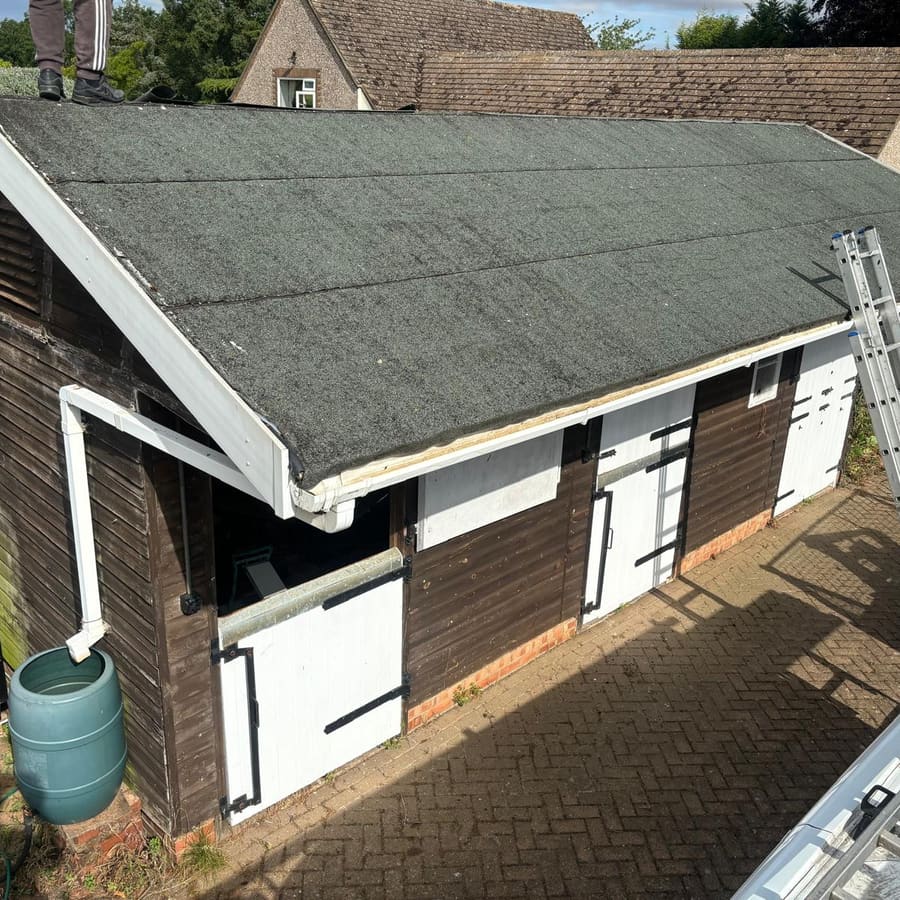 An outbuilding with its old flat roof before renewal