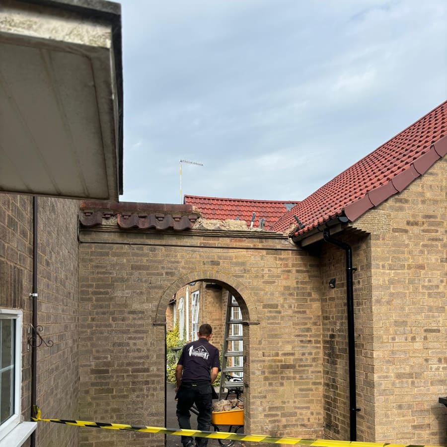 Re-roofing a period property with a brick archway