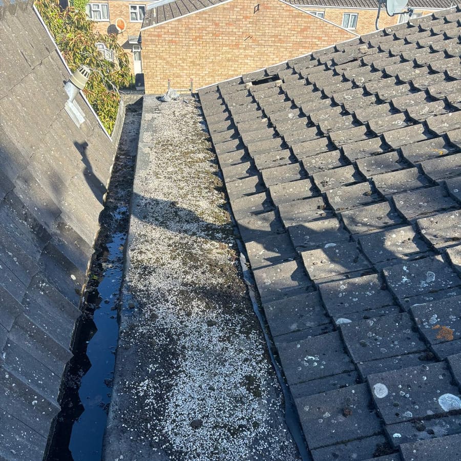 A roof valley cleared and made watertight