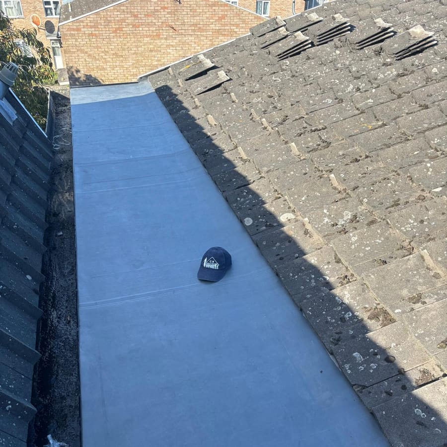 A newly covered flat-roof section beside the tiles