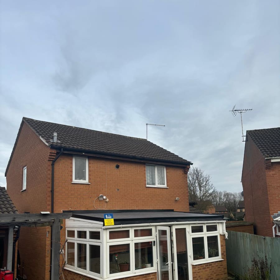 A house with its conservatory roof completed