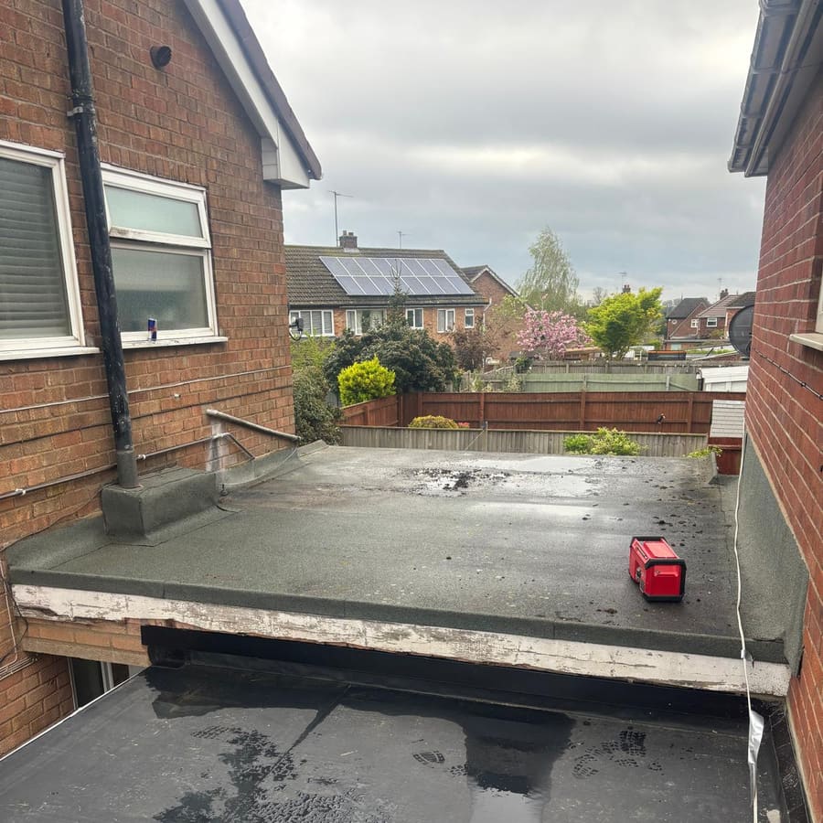 An old garage flat roof stripped back
