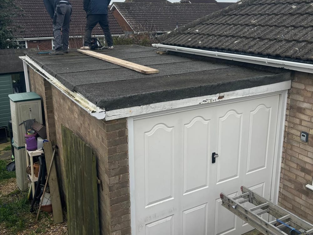 Roofers on a roof making it safe