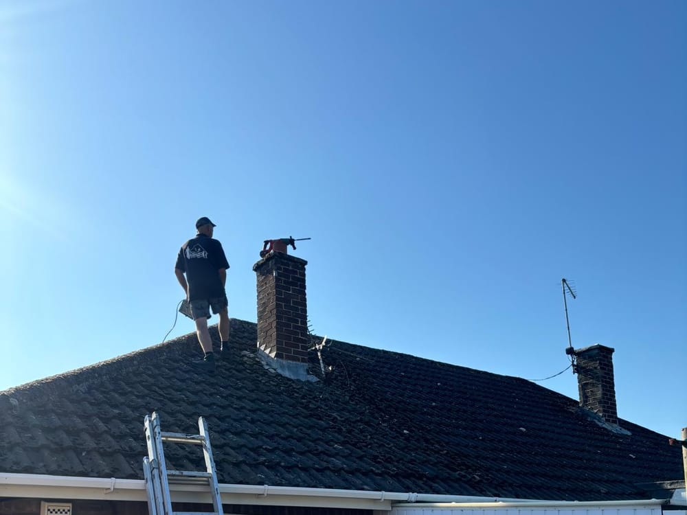 A C R Smith & Son roofer at work on a roof